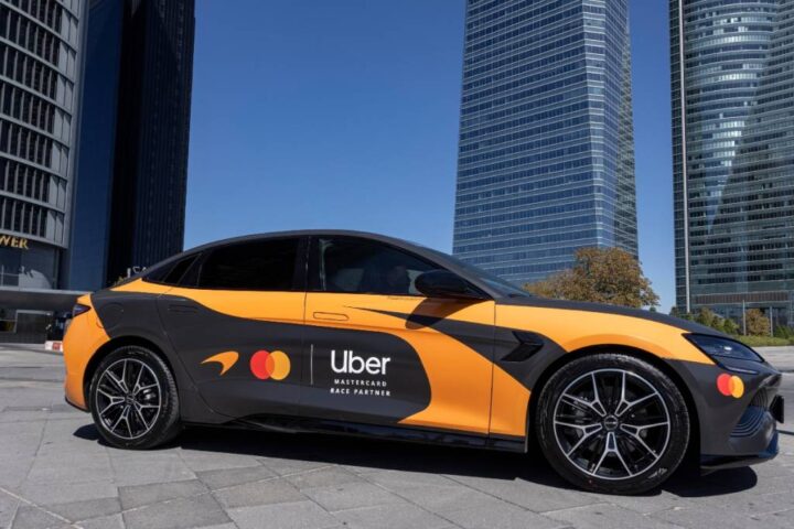 McLaren F1 car beside a papaya Uber in Madrid by The Best Of Ads